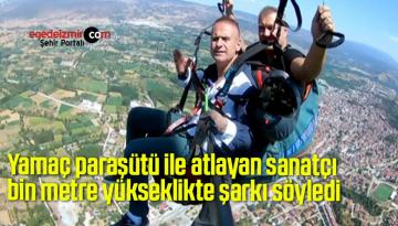 Yamaç paraşütü ile atlayan sanatçı bin metre yükseklikte şarkı söyledi